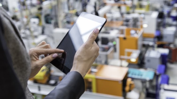 Man in the warehouse using tablet to check the stocks