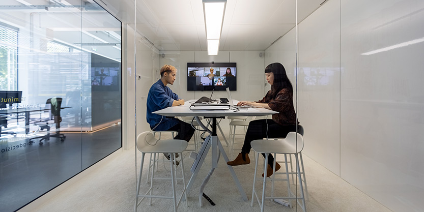 a man and a woman in a meeting room