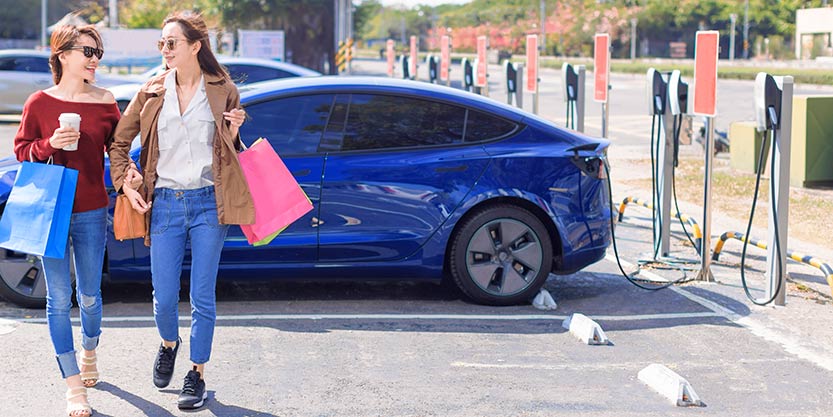 two women in Tesla charging station