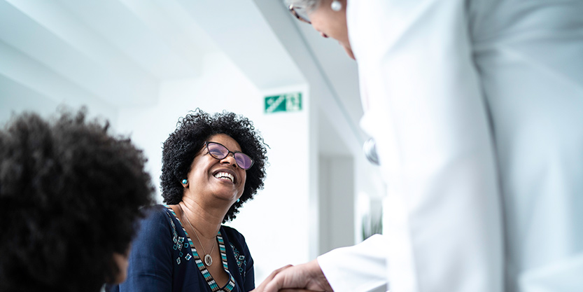 A woman smiling at the nurse