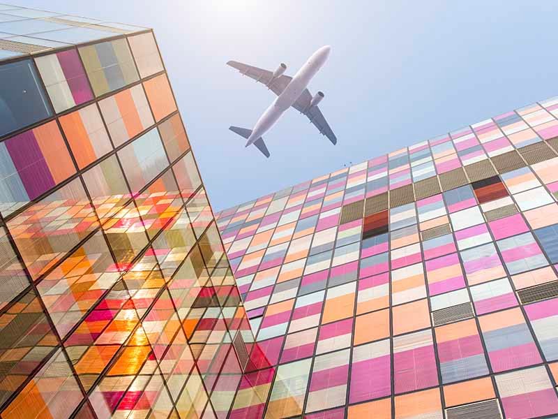 Airplane is flying above the building