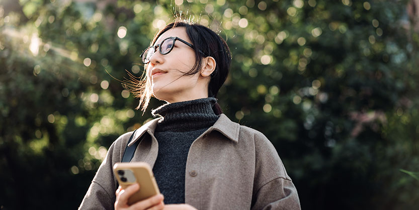 Women standing with a mobile