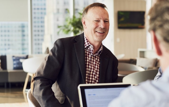 Client having a discussion with expert and smiling