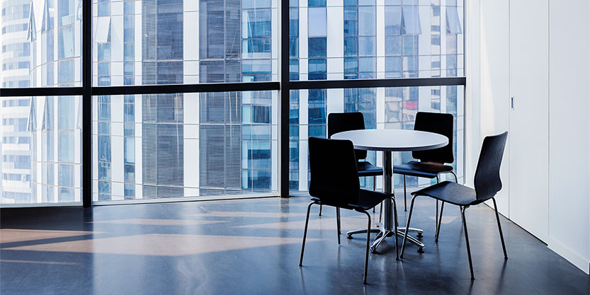 Empty modern office with table and four chairs